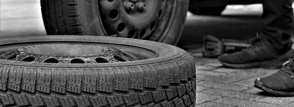 A spare tire is shown on the ground