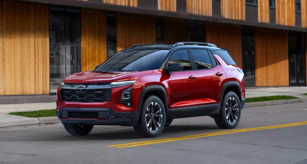 A new red Chevy Equinox driving down a city street, making this SUV the perfect commuter for you. Shop for your new Chevy Equinox at Morristown Chevrolet near Knoxville.